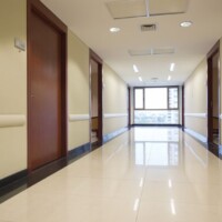 Hallway in hospital with clean floors and large window