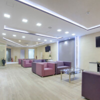 Large waiting room with modern furniture and wooden floors